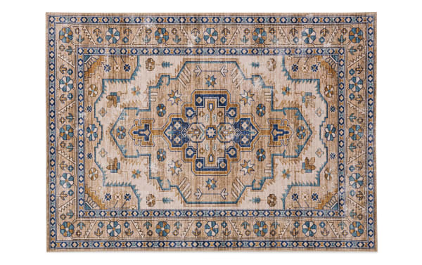 Norah 5' x 7' ivory traditional washable rug with beige and blue geometric floral patterns, stain-resistant polyester fabric, non-slip backing.