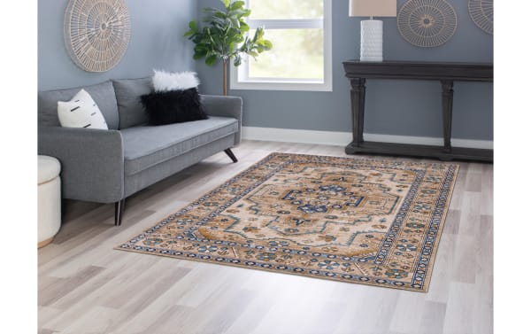 Norah 5' x 7' Ivory Traditional Washable Rug in beige and ivory tones with a classic patterned design, made of stain-resistant polyester fabric.