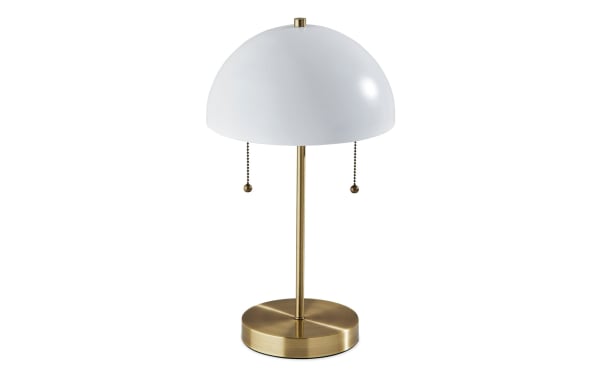 Contemporary Juni table lamp with white dome metal shade and antique brass base, featuring dual pull chains for mid-century modern décor.