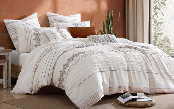 Saffron King White Striped 8 Piece Comforter Set in cotton fabric with white, charcoal, and orange stripes, featuring clipped floating yarns and decorative accent pillows in a transitional style.