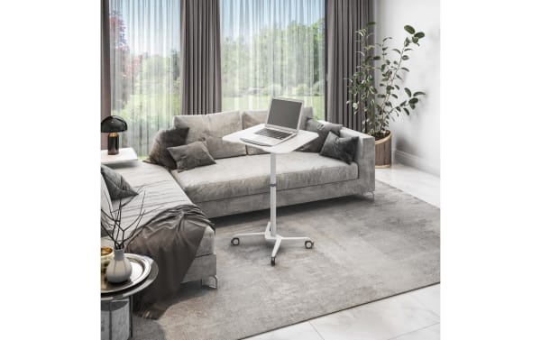 Contemporary Indie White Adjustable Sit/Stand Laptop Desk with MDF top, steel frame, tilting tabletop, edge-stopper, and locking casters in a modern living room.
