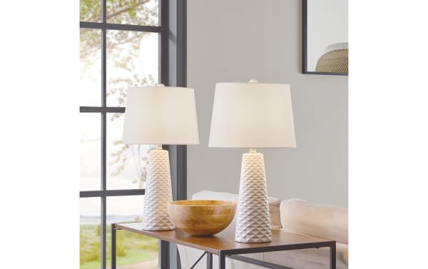 Norah White Table Lamp set of 2 featuring contemporary white ceramic bases with sculptural textured design and fabric shades on a wooden side table.