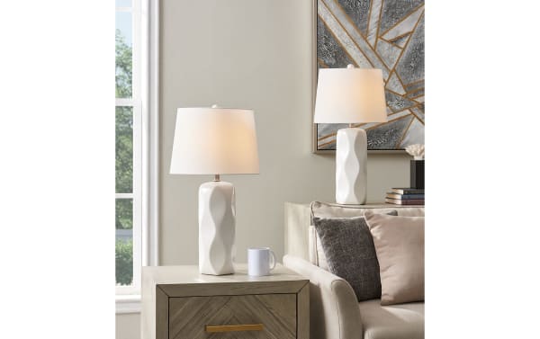 Set of 2 Zayden White Table Lamps with sculptural white ceramic bases and sleek white fabric shades, perfect contemporary lighting for living rooms.