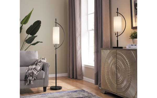 Gabriel 63.5'' black metal floor lamp with a contemporary curved base design and sleek cylindrical white shade, ideal for modern living spaces.