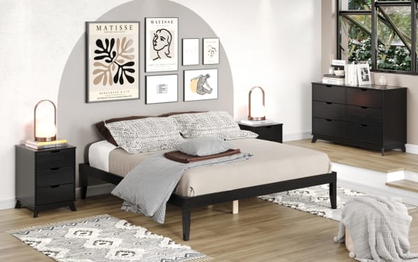 Contemporary Phoebe King black solid pine platform bed with 11.5" underbed storage, beige bedding, matching black nightstands, and abstract Matisse wall art.