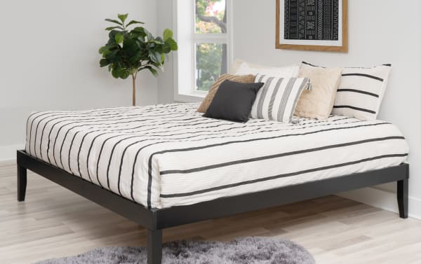 Phoebe King Black Solid Wood Platform Bed with 11.5" underbed storage, contemporary solid pine and plywood frame, black finish, striped bedding.