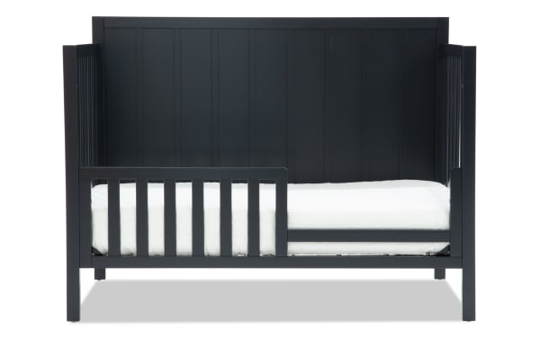Ollie Navy toddler bed conversion rail in transitional style, made of navy pine solids and laminated veneer lumber, for Ollie 4-in-1 crib.