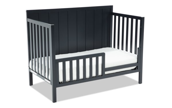 Ollie Navy Toddler Bed Conversion Rail in transitional style, made of navy pine solids and laminated veneer lumber, designed to convert Ollie 4-in-1 crib to toddler bed with safety rail.