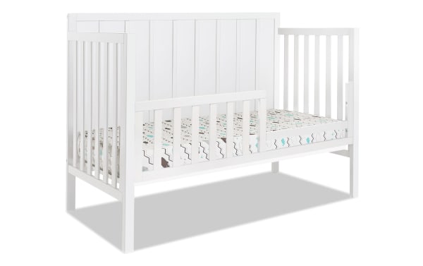 White Ollie Toddler Bed Conversion Rail in transitional style, made of pine solids and laminated veneer lumber, designed to convert a 4-in-1 crib.