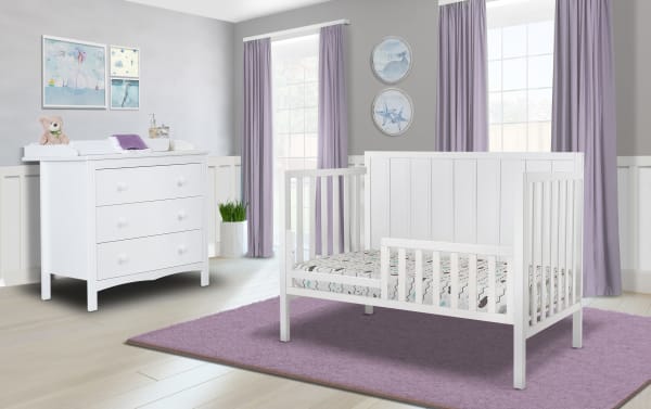 Ollie White Toddler Bed Conversion Rail in transitional style, made of white pine solids and laminated veneer lumber, shown on a convertible crib.