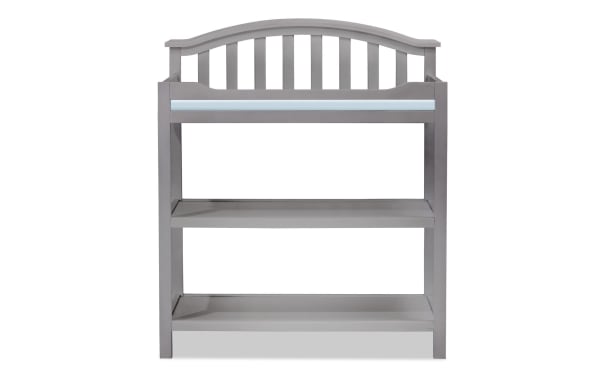 Finlay Gray Changing Table in transitional style with gray pine wood, curved back silhouette, safety rail, and two open storage shelves.