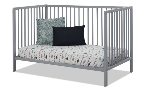 Primrose Gray 3-in-1 Convertible Crib from Primrose Avery collection, contemporary gray beech wood toddler bed with slatted sides and patterned mattress.