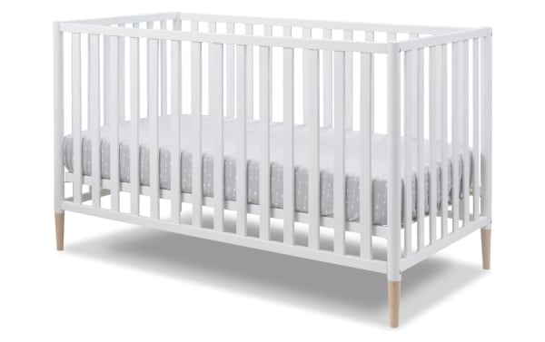Jasper White 3-in-1 Convertible Crib in solid wood with a contemporary Scandi design, white finish, and removable natural wood legs.