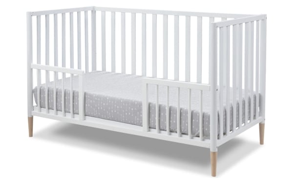 Jasper White 3-in-1 Convertible Crib in solid wood with contemporary Scandi design, white finish, removable feet, and toddler bed conversion kit.