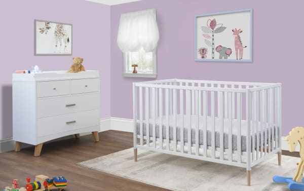 Contemporary Jasper White 3-in-1 convertible crib in solid wood with removable colored feet, paired with white changing table and nursery decor.