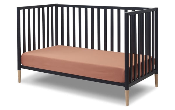 Jasper Navy 3-in-1 Convertible Crib in solid wood with navy finish and natural wood tapered legs, contemporary Scandi style, converts to toddler bed and daybed
