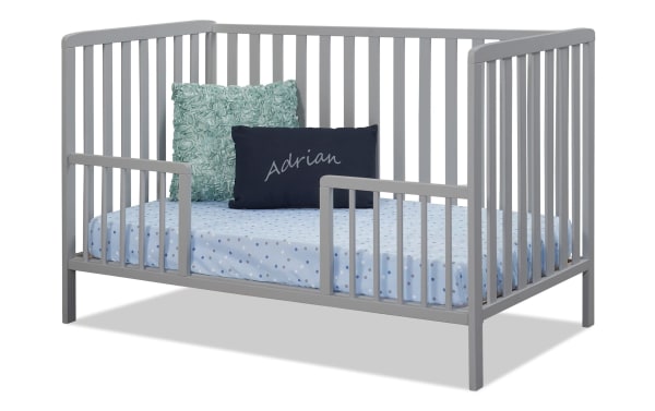 Avery/Primrose Gray Toddler Conversion Rail in transitional style, made of gray wood, attached to convertible crib to prevent toddler from rolling out.