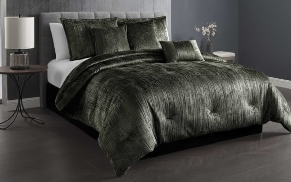 Luxurious dark green velvet comforter set on a modern bed with matching pillows, featuring a soft, textured finish for elegant bedroom decor.