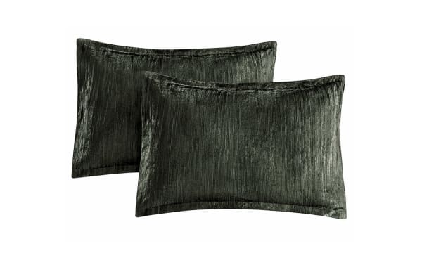 Set of two dark green velvet rectangular pillow shams with a subtle textured stripe pattern, designed for decorative bedroom use.