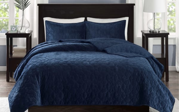 Camille King/California Navy Geometric 3 Piece Quilt Set featuring navy polyester velvet fabric with a geometric quilted design, soft microfiber and cotton blend, glam style bedding with matching pillow shams for a comfortable, stylish sleep space.