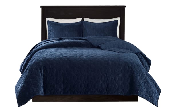 Camille King/California Navy Geometric 3 Piece Quilt Set with polyester velvet fabric, rich navy blue color, geometric quilted design, and matching shams for a glam, soft, and casual bedroom update.