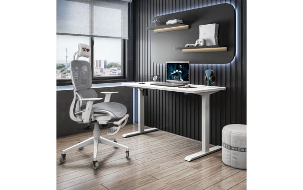Gray Daxton Gray Gaming Chair with breathable mesh, adjustable armrests, reclining back, and footrest in contemporary office setup.