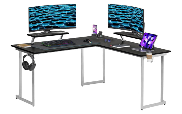 Zuma Silver Adjustable L-Shaped Gaming Desk with black MDF top, silver power-coated steel frame, dual adjustable monitor shelves, cup holder, and headphone hook for ergonomic gaming or home office setup.
