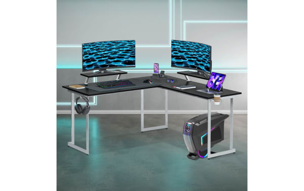 Zuma Silver Adjustable L-Shaped Gaming Desk in contemporary style with black MDF top, silver power-coated steel frame, dual adjustable monitor shelves, cup holder, and headphone hook, ideal for dual-monitor gaming or home office setups.