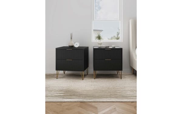 Delilah Black 2 Drawer Nightstand set in contemporary style with vertical ribbed MDF fronts, splayed gold metal legs, full extension, and soft-close drawers.