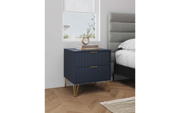 Delilah Blue 2 Drawer Nightstand in contemporary style with navy MDF body, vertical ribbed drawer fronts, and gold splayed metal legs, soft-close drawers.