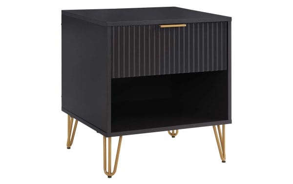 Delilah Black Nightstand with Drawer featuring vertical ribbed drawer front, splayed gold metal legs, MDF construction, and soft-close drawer in contemporary style.