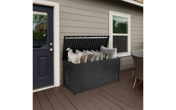 Osgood 113 Gallon Black Outdoor Storage Box in contemporary style, made of durable resin and metal with faux-wood slat design, waterproof and fade-resistant, featuring an easy-open lid and spacious 113-gallon capacity for patio storage.