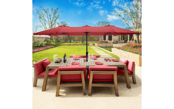 Gomez 15' red outdoor market umbrella with fade-resistant polyester canopy, steel ribs, and hand crank, paired with red cushioned patio dining set.