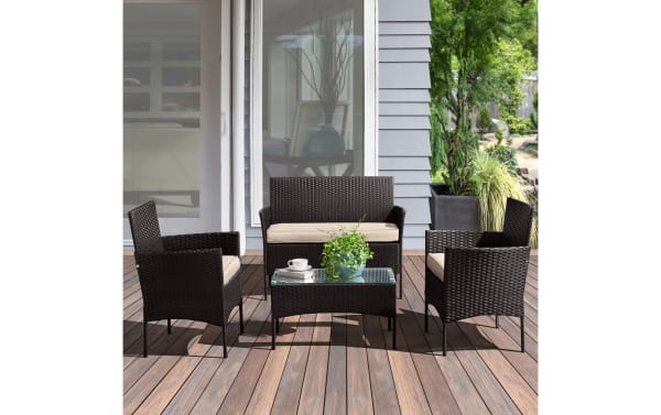 Callum 4 Piece Black Rattan Outdoor Conversation Set with beige cushions, featuring PE rattan, powder-coated steel frame, and glass coffee table.