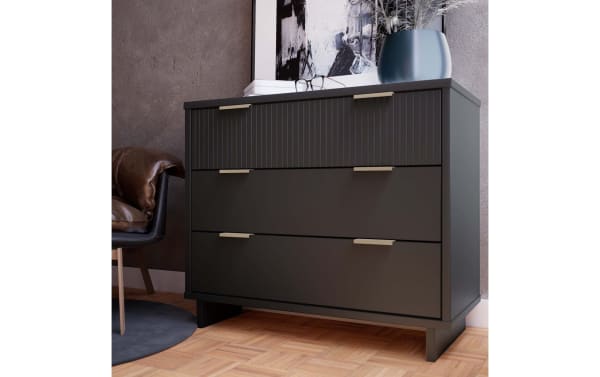 Contemporary Ascias Charcoal 3 Drawer Dresser in solid wood with vertical-ribbed top drawer, full-extension soft-close drawers, mop base legs, and metal handles.