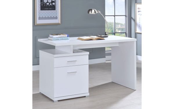 Eliana White 2 Drawer Desk in contemporary style, made of MDF, paper, and particle board. Features a spacious white workspace, storage drawer, and file cabinet, ideal for small-space office setups.