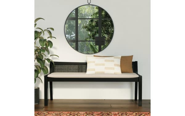Contemporary Bridget Black Rattan Cane Bench with beige polyester fabric cushion, natural rubberwood frame, rattan cane back, and decorative pillows.