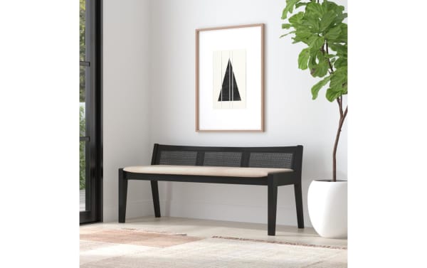 Contemporary Bridget Black Rattan Cane Bench with beige polyester fabric seat, black rubberwood frame, and natural rattan cane backrest for cozy seating.