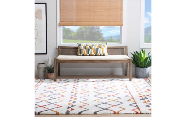 Contemporary Bridget Brown Rattan Cane Bench with beige polyester fabric seat, natural rubberwood frame, and rattan cane backrest for cozy seating.
