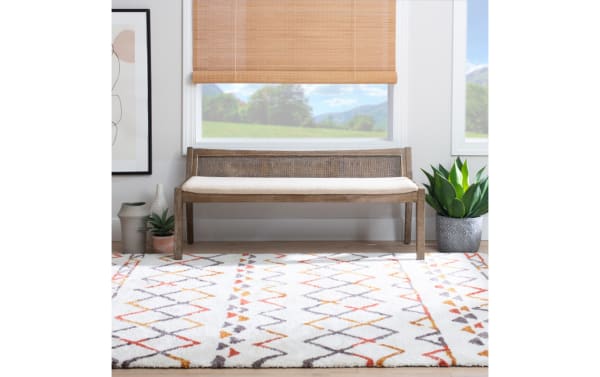 Contemporary Bridget Brown Rattan Cane Bench with beige polyester fabric cushion, natural rubberwood frame, and woven rattan backrest for cozy seating.