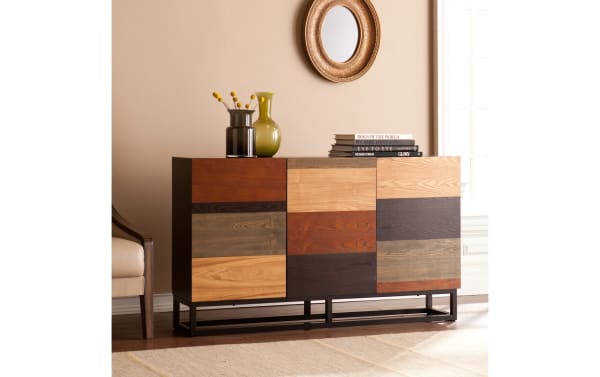 Gabrielle Brown & Black Server with mid-century modern style, featuring multi-tonal ash veneer doors in brown, black, and natural wood tones, MDF construction, and powder-coated iron base. Three mismatched cabinet doors open to adjustable shelves for storage, ideal for linens, media, or entertaining accessories.