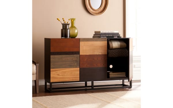 Gabrielle Brown & Black Server in mid-century modern style with multi-tonal ash veneer doors, MDF body, and powder-coated iron base, featuring mismatched wood finishes and adjustable shelves behind three cabinet doors.
