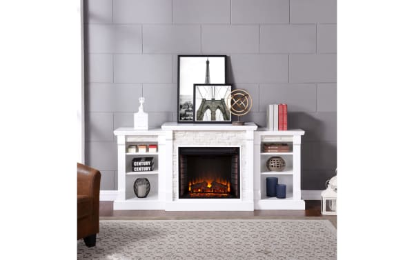 Norin 71.8'' white traditional electric fireplace and TV stand in MDF and poplar solids, featuring five LED flame settings, dual bookshelves, and rustic resin decor.