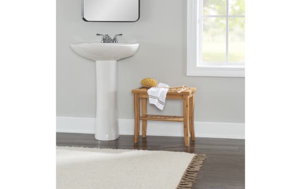 Branson Natural Bathroom Stool in bamboo with a curved top, small lower shelf, and slightly splayed legs, ideal for transitional bathroom storage.