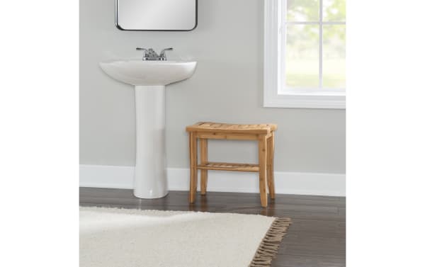 Branson Natural Bathroom Stool in bamboo with a curved top, small lower shelf, and splayed legs, ideal for transitional bathroom decor.