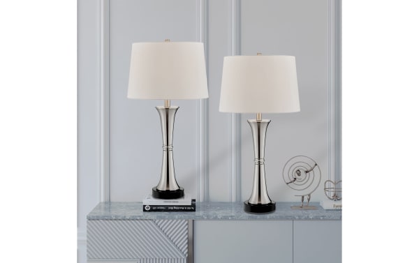 Set of 2 Ferrara brushed nickel table lamps with white fabric shades, sleek candlestick metal bases, and contemporary design for modern decor.