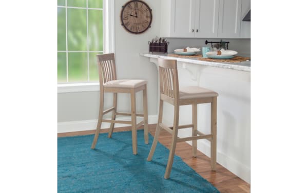 Two beige Craftsman Slat Back Bar Height Stools with padded polyester seats, rubberwood frame, and traditional mission-back style at kitchen counter.