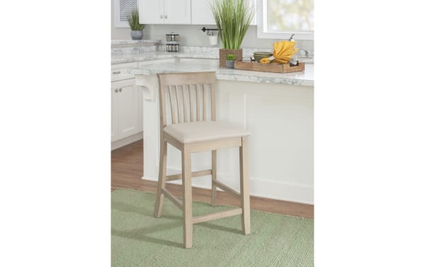 Beige Craftsman Slat Back Counter Height Stool with padded polyester fabric seat, rubberwood and MDF frame, traditional mission-back style, rustic finish.