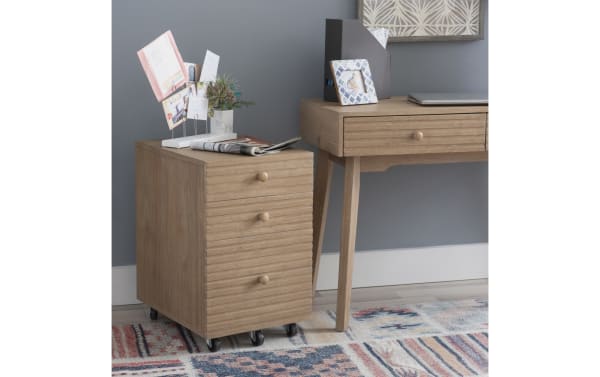Rylan Natural 2 Drawer File Cabinet in rubberwood and MDF with rolling casters, mid-century modern style, natural wood finish, and horizontal drawer grooves.