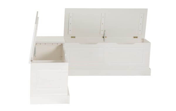 White wooden L-shaped storage bench with hinged lids open, featuring paneled sides and brass hardware for indoor seating and storage.